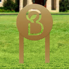 Metal sign featuring a logo on a grassy outdoor background, custom laser-cut design for business branding and decorative outdoor signage