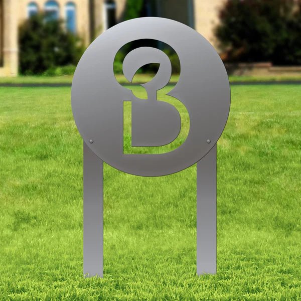 Custom metallic sign featuring a symbol on a grassy outdoor background, laser-cut design for decorative outdoor signage and personalized metal décor