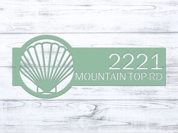 Green seashell metal address plaque on white wooden background, personalized house number sign, coastal front door décor, outdoor nautical metal sign, custom home signage