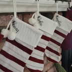 Red and white striped Christmas stockings with names hanging on fireplace, personalized festive holiday décor for seasonal home display