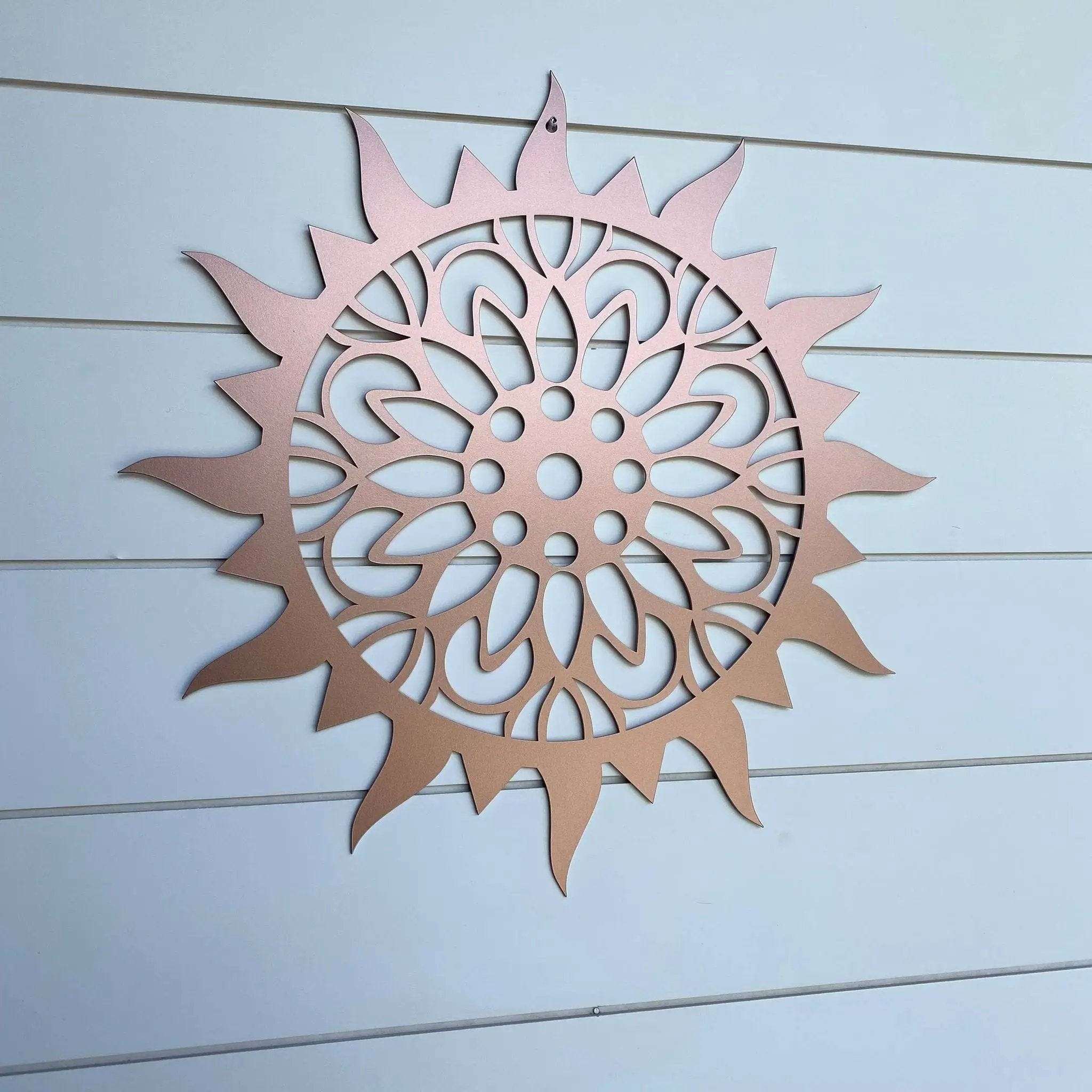Sunburst sunflower metal wall art, decorative outdoor plaque on light wooden background, powder coated for durability