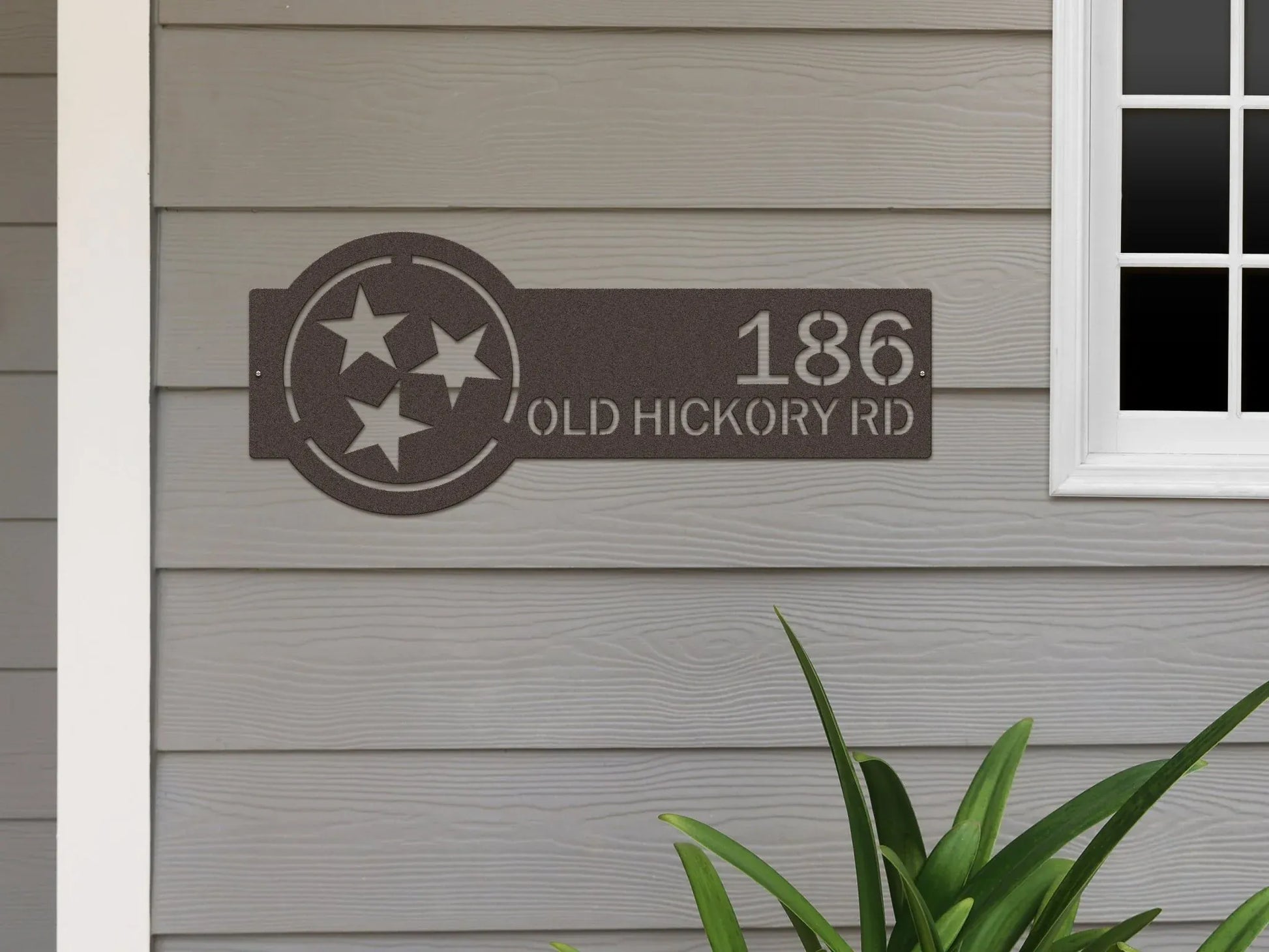 Oil rubbed bronze Tennessee Tristar Address Sign featuring a Tristar emblem on the right and house number '186 Old Hickory Rd' on the left, mounted on the wall.