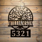Metal wall art with tree design and house numbers "Williamson 5321" on wooden background, custom outdoor address plaque, decorative home exterior signage