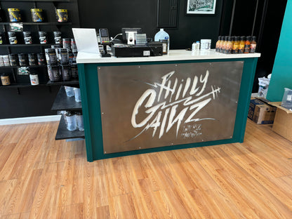 Hand Brushed BACKLIT Aluminum Business Logo Sign displayed on a counter, featuring a precision laser-cut design and durable powder coating, perfect for storefronts, offices, and company logo displays.