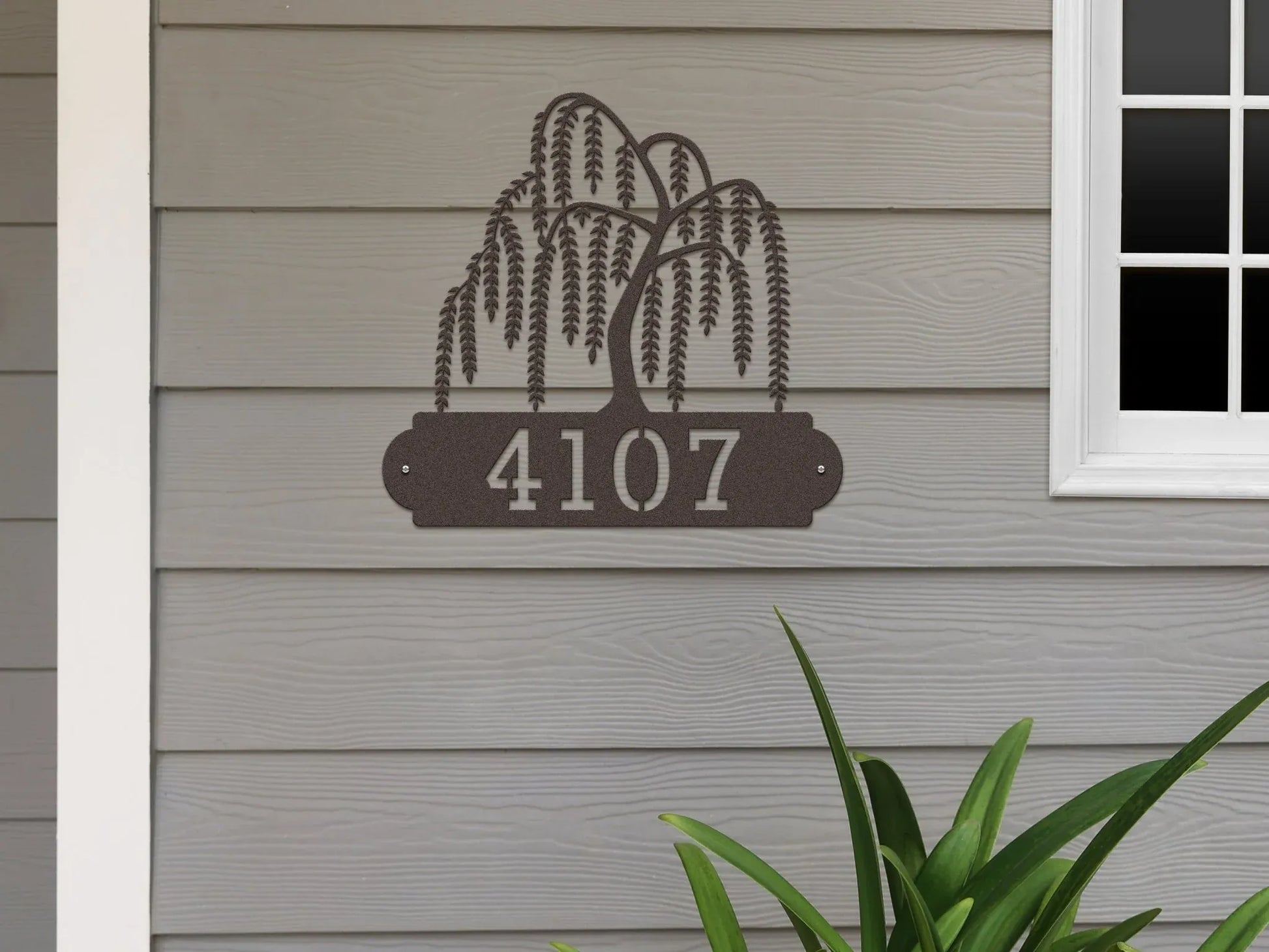 Oil burged Weeping Willow Address Sign with tree design on top and house number '4107' below, mounted on door wall.