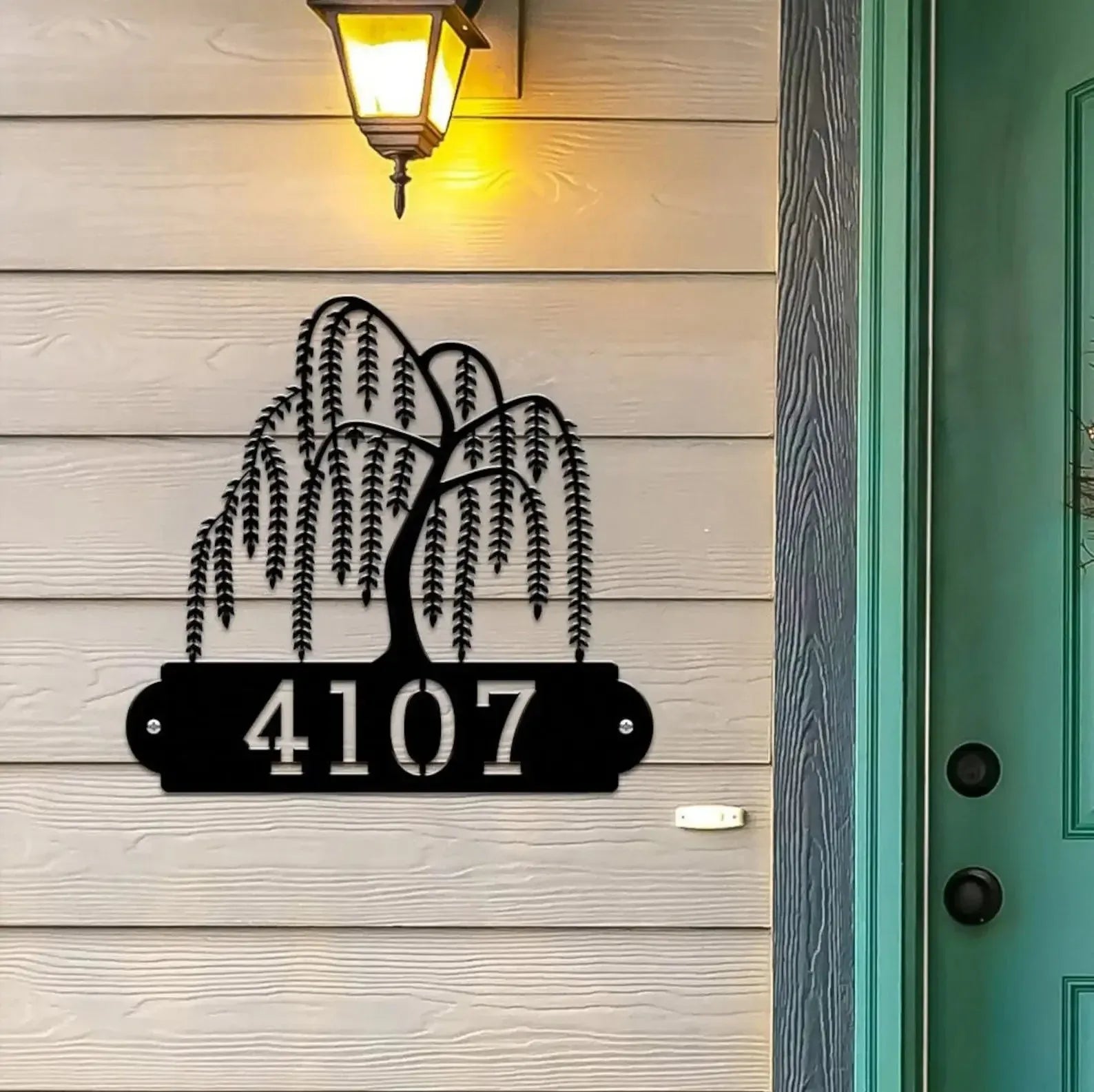 Black Weeping Willow Address Sign with tree design on top and house number '4107' below, mounted on beige door wall.