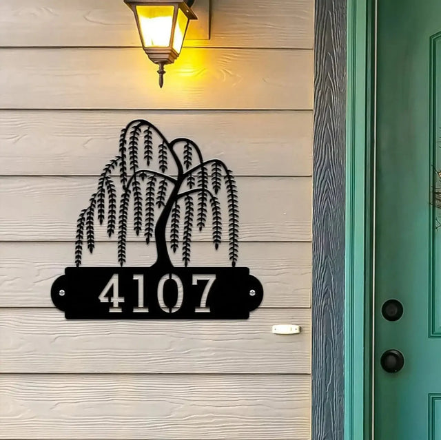 Black Weeping Willow Address Sign with tree design on top and house number '4107' below, mounted on beige door wall.