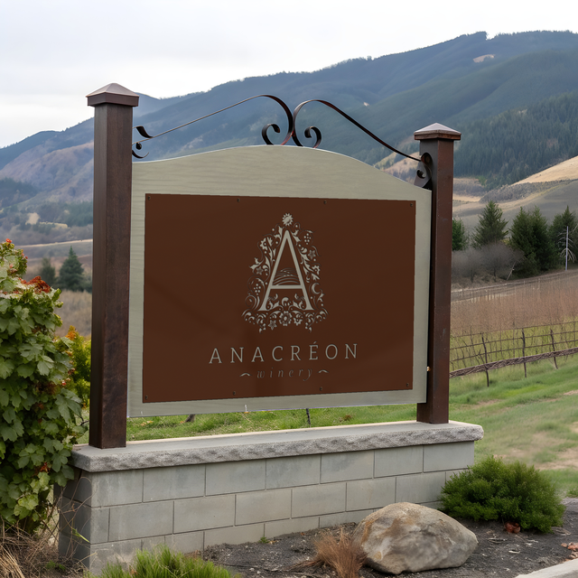 Elegant winery monument sign with custom logo and vineyard name, set in stone or wood for a rustic, upscale appearance.