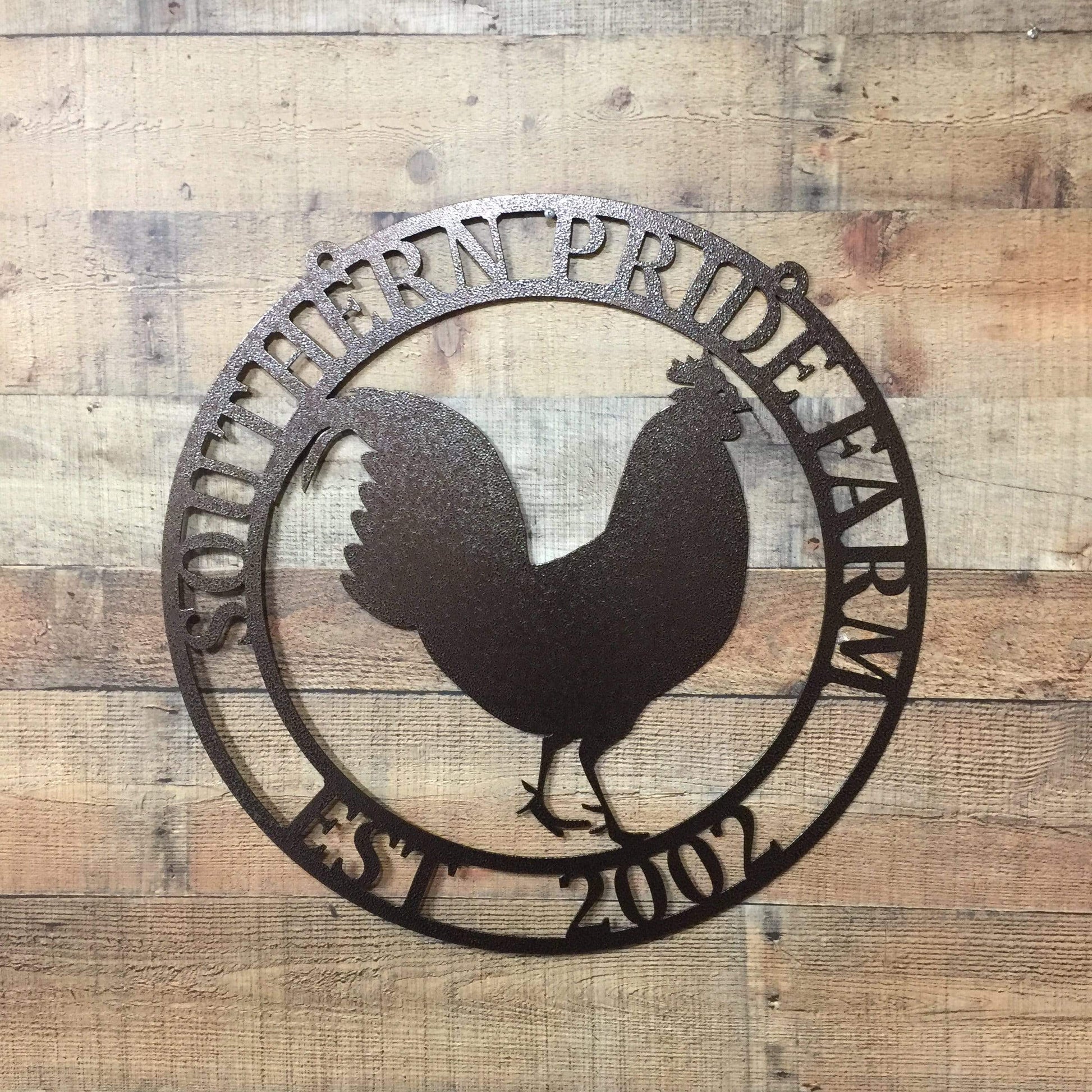 Oil rubbed bronze circular ranch metal sign with rooster cutout and “SOUTHERN PRIDE FARM EST. 2002” on brick wall.