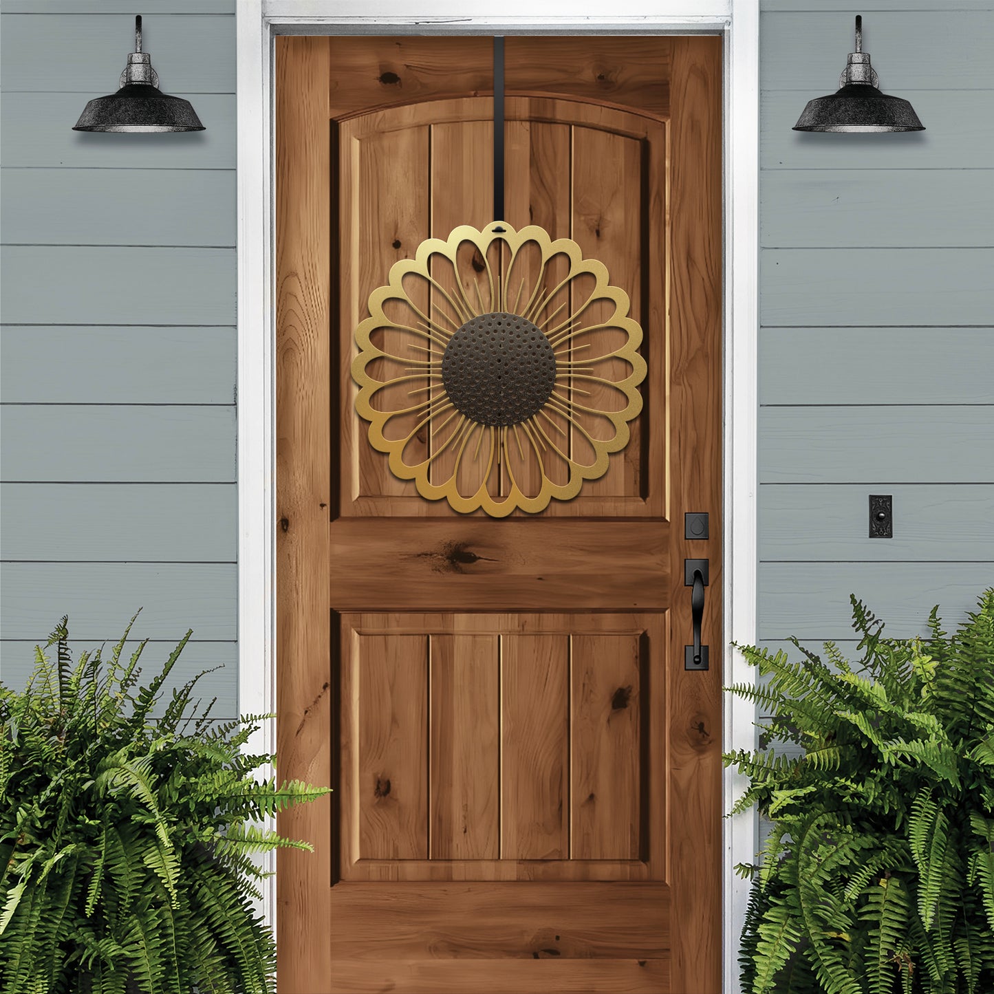 a wooden door with a metal sunflower decoration on it