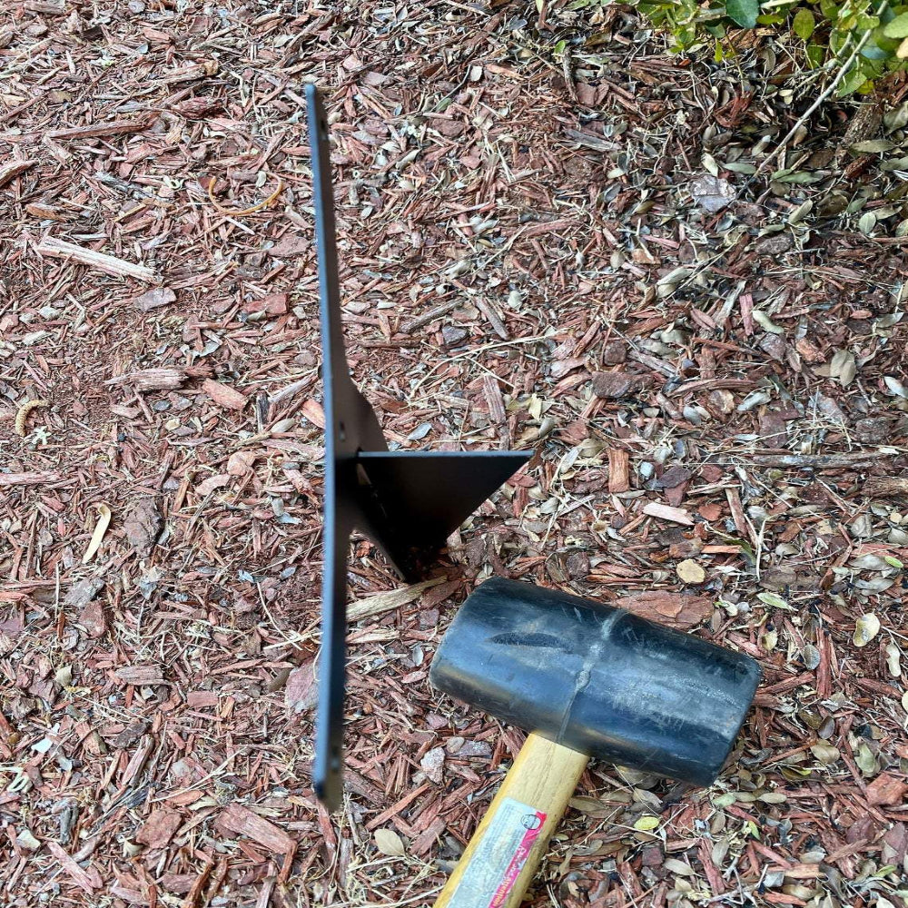 Personalized metal garden stake sign, back view showing metal spike and wooden handle installed in mulch bed outdoor garden décor.