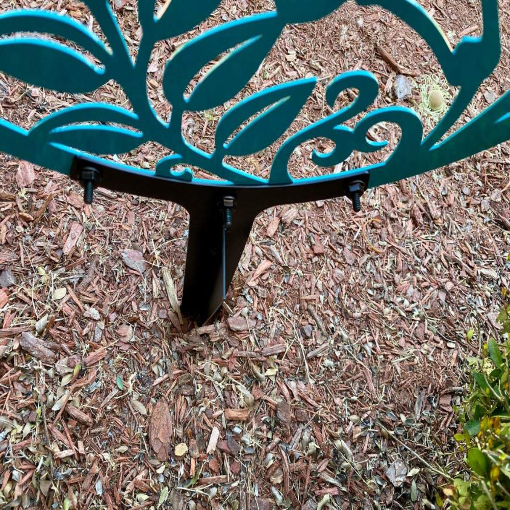 Personalized metal garden stake sign, back view with screws visible, outdoor décor installed in mulch bed for garden display.