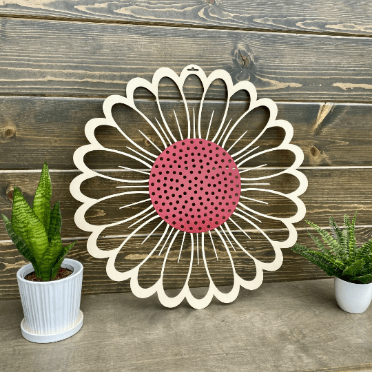 Close-up sunflower metal wall art with pink center on wood backdrop, rustic farmhouse décor, custom color powder coated metal sign, outdoor home accent design