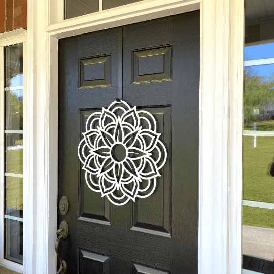 White circular metal flower wreath on dark gray front door, modern floral wall decor, handcrafted outdoor metal sign, elegant home entryway design
