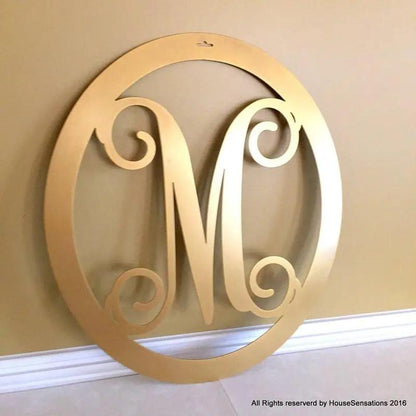 Gold M monogram wreath with house view – custom metal front door decor with initials. 