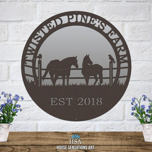 An oil rubbed bronze custom laser cut metal ranch sign showing horses in pasture, with “TWISTED PINE’S FARM EST 2018” text.