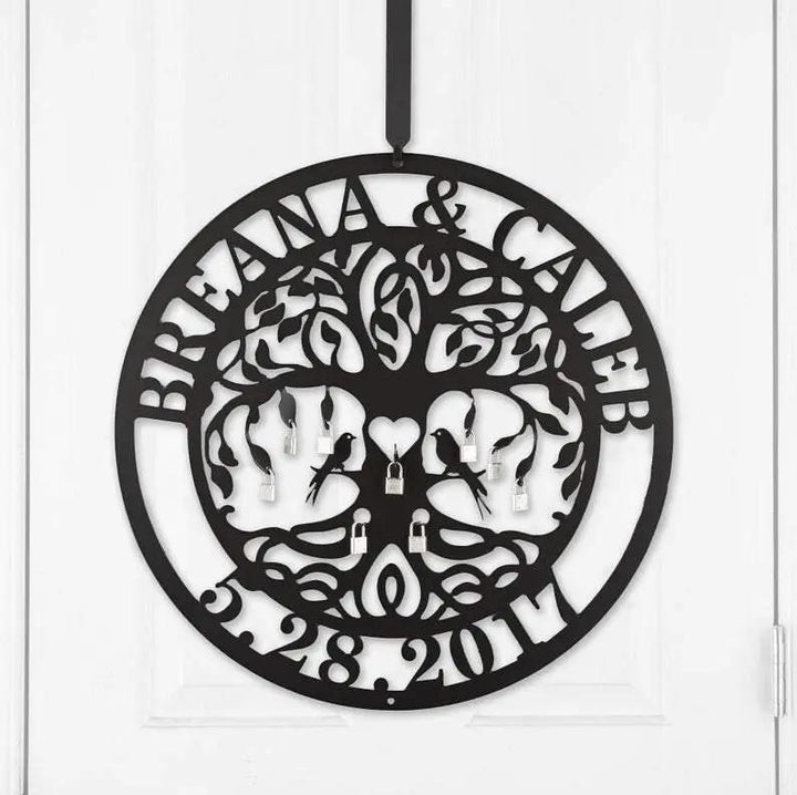 Close-up of black personalized Love Locks metal wall art on a white door