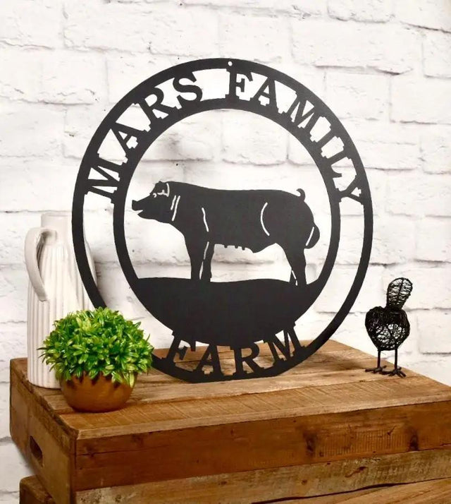 Black laser cut farm sign made of steel, featuring pig in a scenic layout and custom resort text personalized outdoor decor.