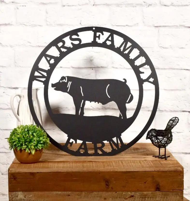Oil-rubbed bronze laser cut ranch sign with pig in a farm scene and custom resort name personalized steel outdoor decor.
