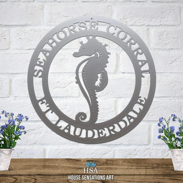 Polished chrome metal sign with cut-out seahorse silhouette and “SEAHORSE CORRAL” and “FT LAUDERDALE” in border, mounted.