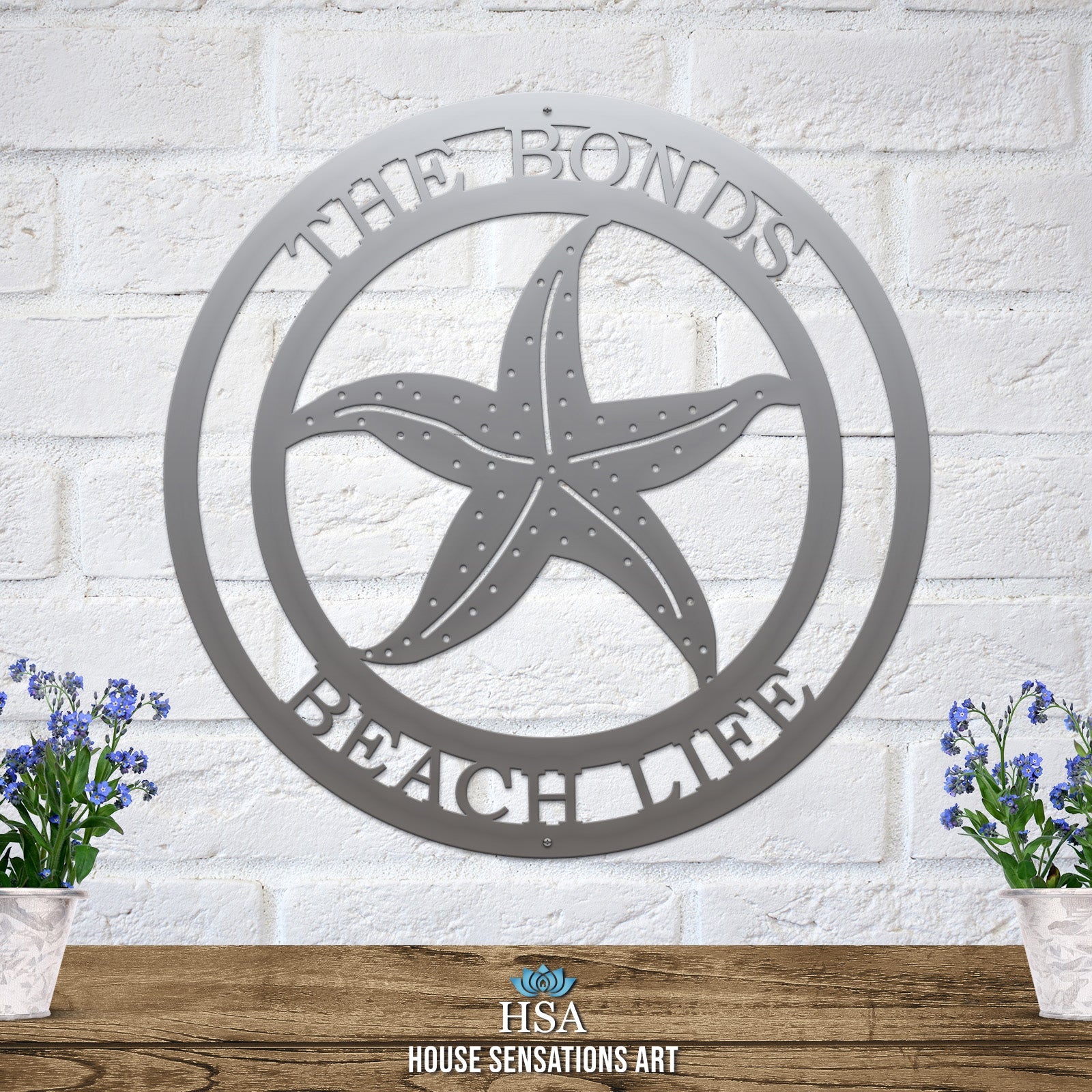 Polished chrome custom laser cut metal beach sign with starfish and “THE BONDS BEACH LIFE” text, coastal outdoor decor.