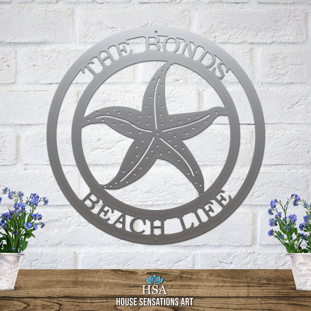 Polished chrome custom laser cut metal beach sign with starfish and “THE BONDS BEACH LIFE” text, coastal outdoor decor.