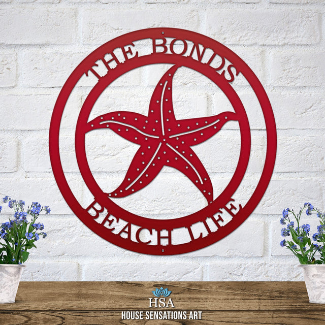 Deep red custom laser cut metal beach sign with starfish and “THE BONDS BEACH LIFE” text, coastal outdoor decor.