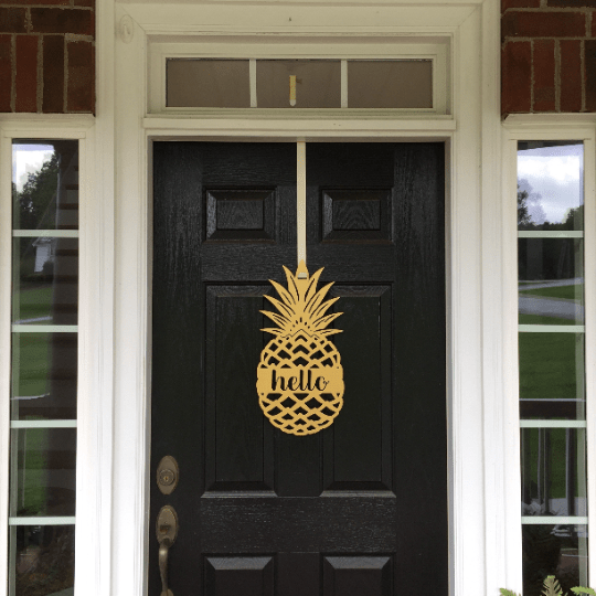 Black front door with gold pineapple hello metal hanging sign, tropical entry décor, brick home curb appeal, custom powder coated welcome wall art sign