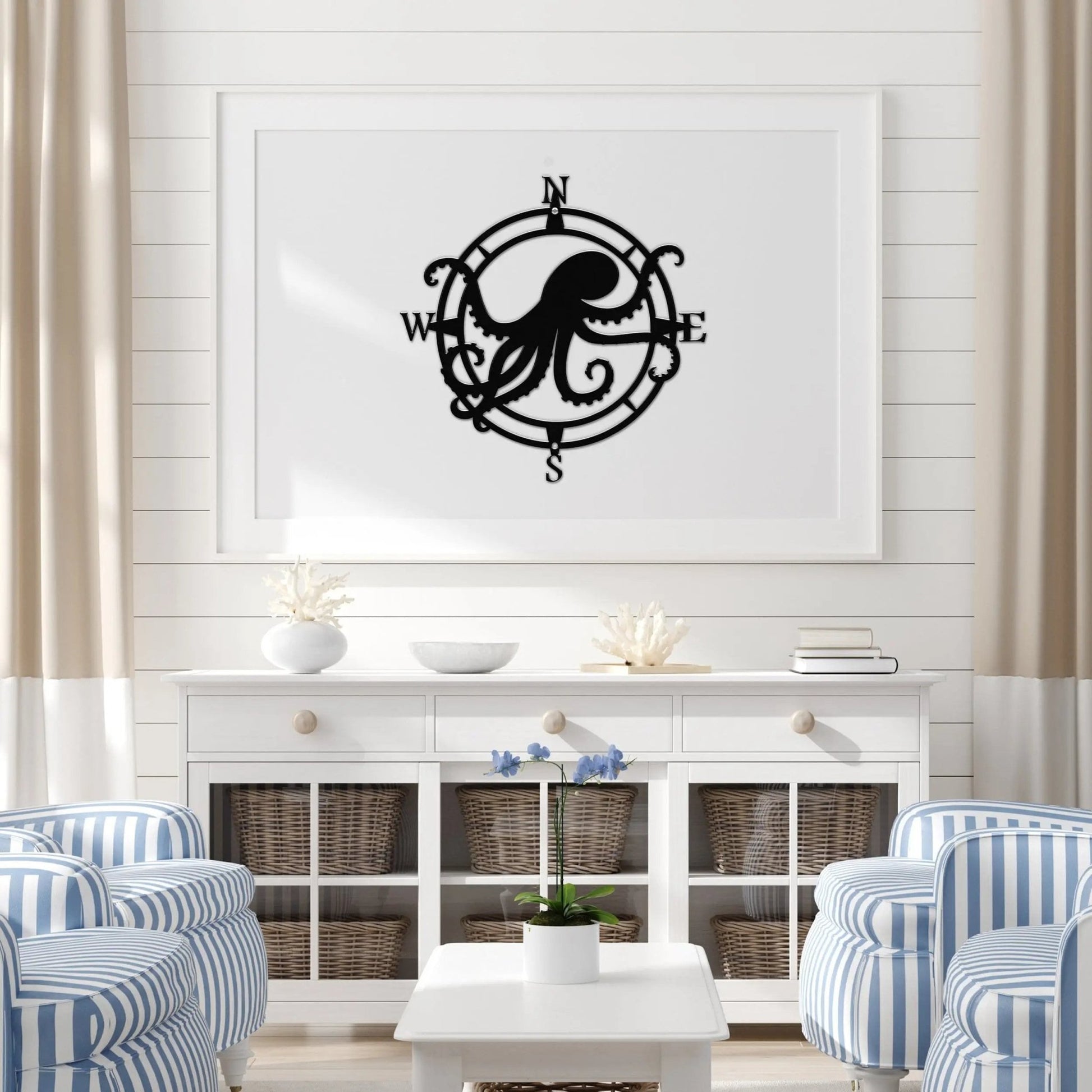 Textured black circular compass sign with a central octopus, arms reaching west and east; adds charm to indoor beach decor.