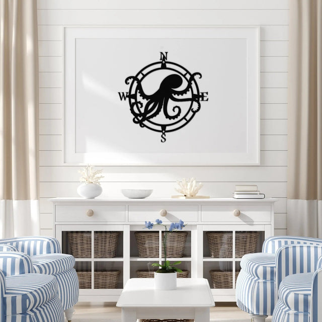 Textured black circular compass sign with a central octopus, arms reaching west and east; adds charm to indoor beach decor.