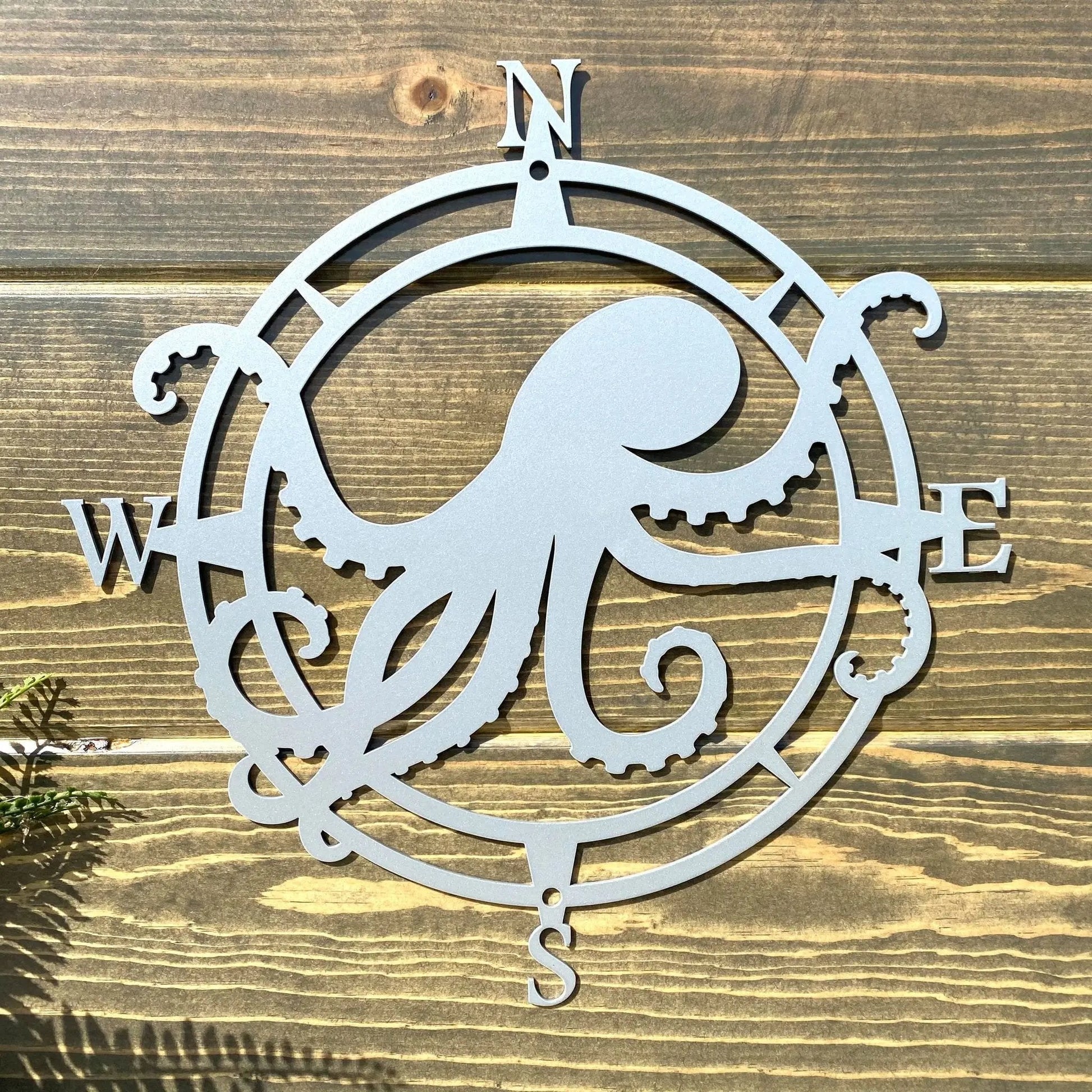 Polished chrome circular compass sign, octopus centered with west/east tentacles, great for entryway or porch decor.