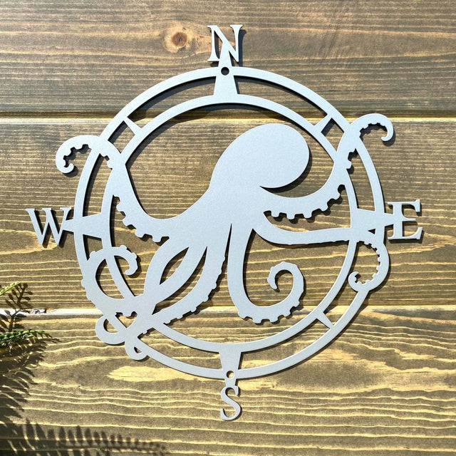 Polished chrome circular compass sign, octopus centered with west/east tentacles, great for entryway or porch decor.