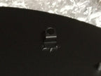 Weld mount system adhesive fastener close-up, black mounting hardware with metallic logo, strong no-drill solution for metal signs and outdoor décor installation